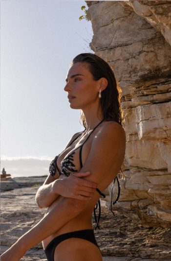 Nadia Triangle 17 Nadia Triangle in deep noir adjustable ties artisanal glass beads cascading over chiffon embroidery embodying refined seduction in golden coastal light