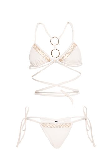 Rhea Bikini 35 RHEA black bikini with gold accents and adjustable ties sensual pose with arms raised against ocean backdrop gost white front